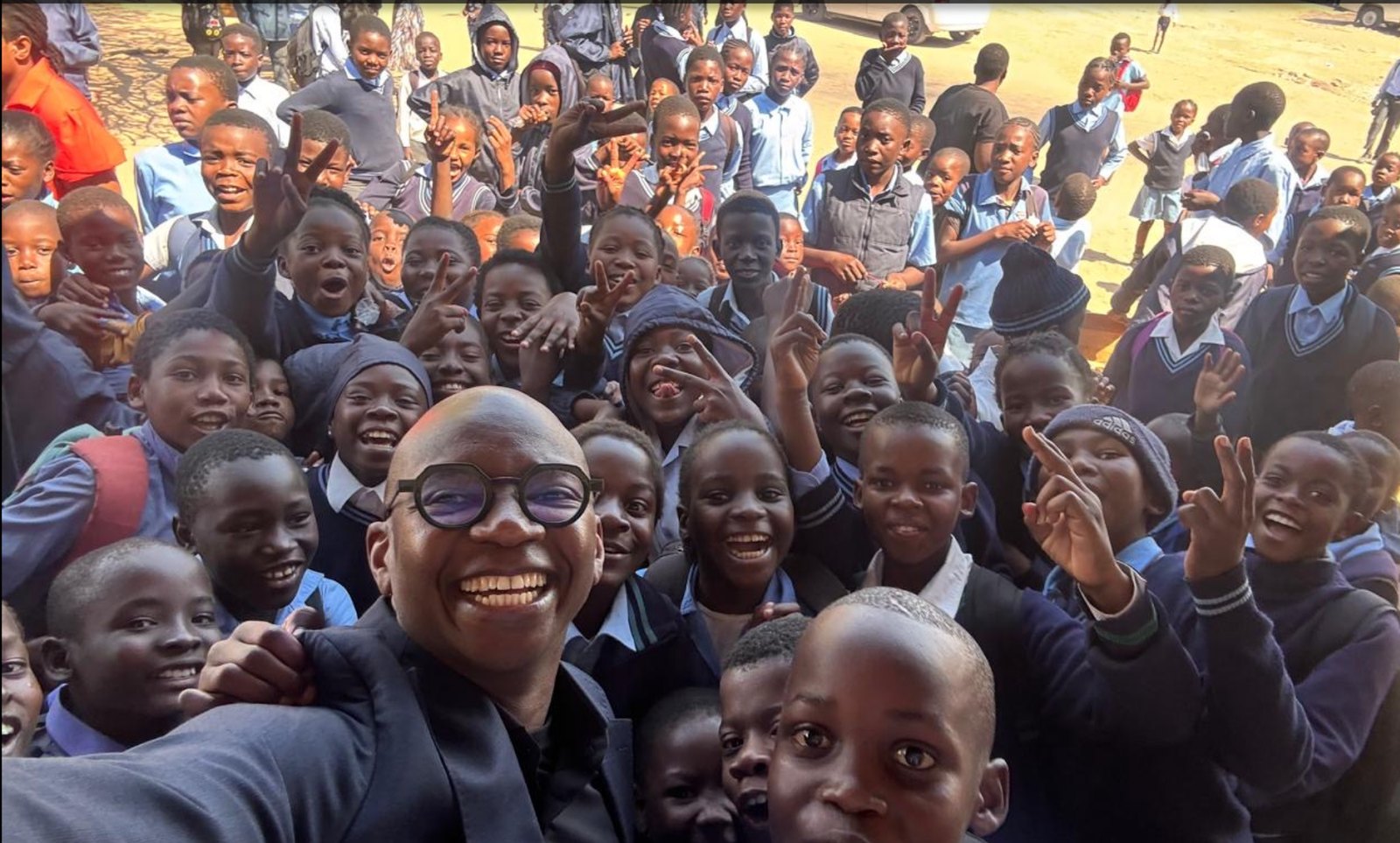 Nyimpini Mabunda surrounded by learners on a school visit